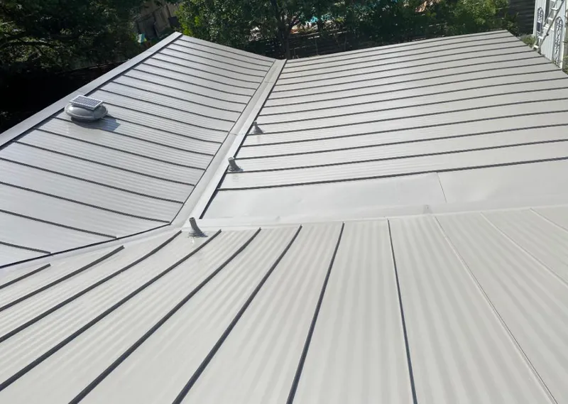 Solar attic fan installed on a metal roof for Roof Ventilation in Trophy Club